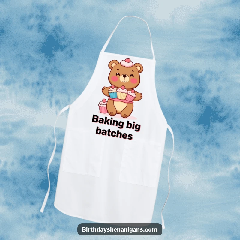 Funny apron showing a cheerful bear character expertly balancing a stack of cupcakes. Perfect for adding fun to baking.