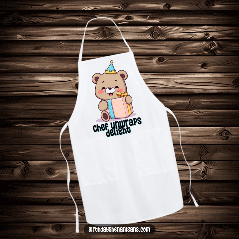 Funny apron with a smiling bear in a birthday crown, joyfully unwrapping a comically oversized gift, perfect for a celebratory cook.