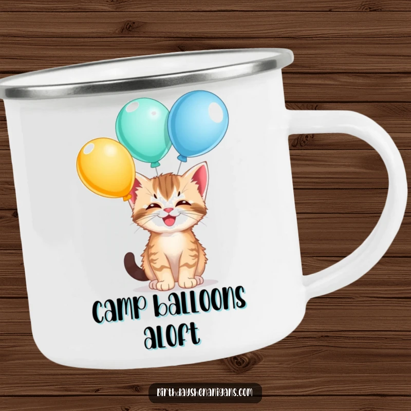 Funny kitten camping mug, durable, giggling, balancing balloons, outdoor sipping, feline flair, humorous.