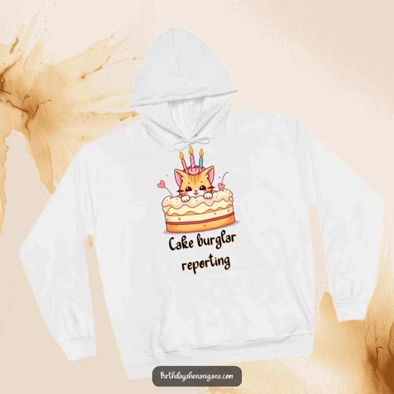 Funny hoodie featuring a playful cat character peeking out from a giant, decorated birthday cake, perfect for cozy celebrations.