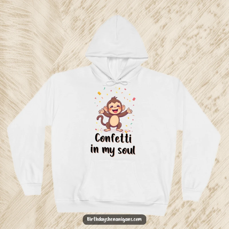 Funny hoodie featuring a kawaii monkey throwing confetti with glee, perfect for cozy celebrations and a delightful funny gift.