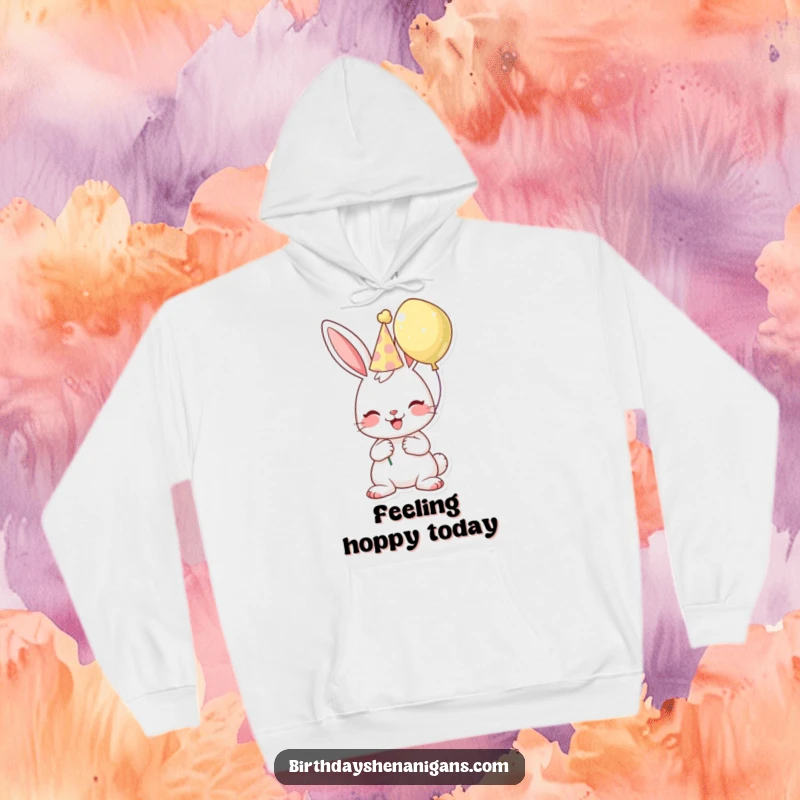 Funny birthday hoodie showing a cheerful bunny in a party hat, holding a balloon, perfect for cozy celebrations.