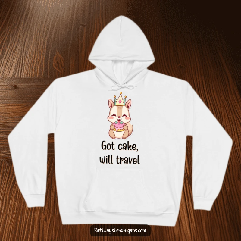 Funny Squirrel Hoodie: Joyful character wears crown, stuffs cheeks with cake, perfect for cozy indulgence.
