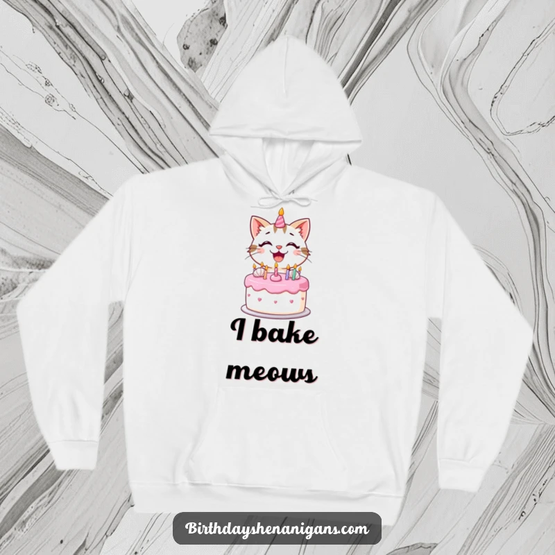 Funny kawaii cat with a big smile decorating a birthday cake with frosting on a cozy hoodie.