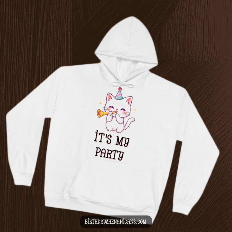 Funny kawaii cat wearing a birthday hat blowing a trumpet on a cozy hoodie, comfortable and festive. Hilarious gift.