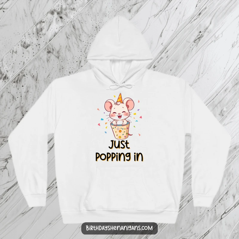 Funny mouse character popping out of a party popper, showering confetti, a cozy and humorous hoodie for party lovers.