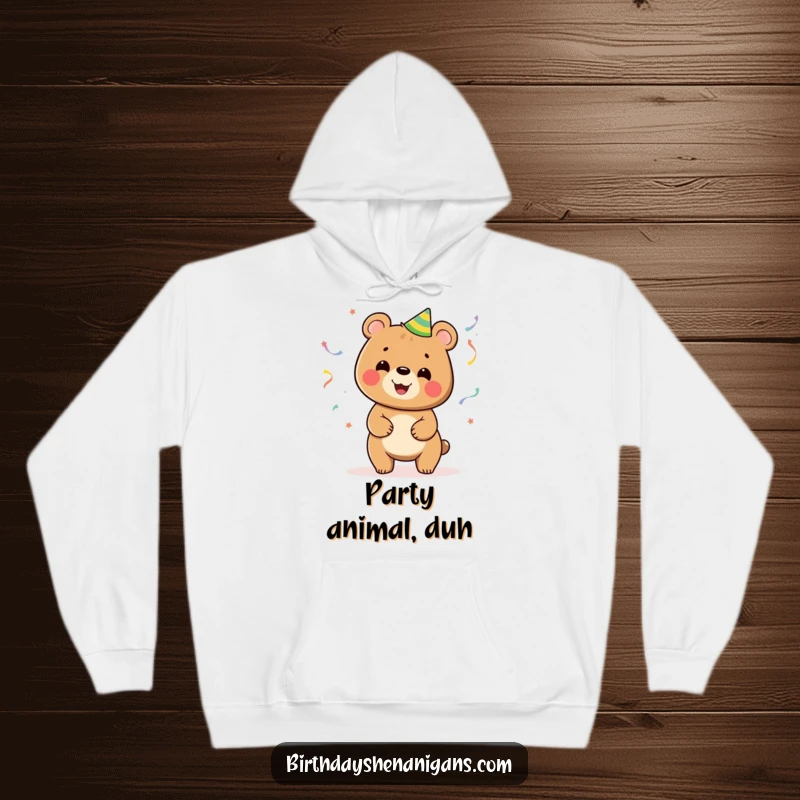 Funny hoodie design of a smiling bear energetically juggling numerous colorful party streamers, conveying festive cheer.