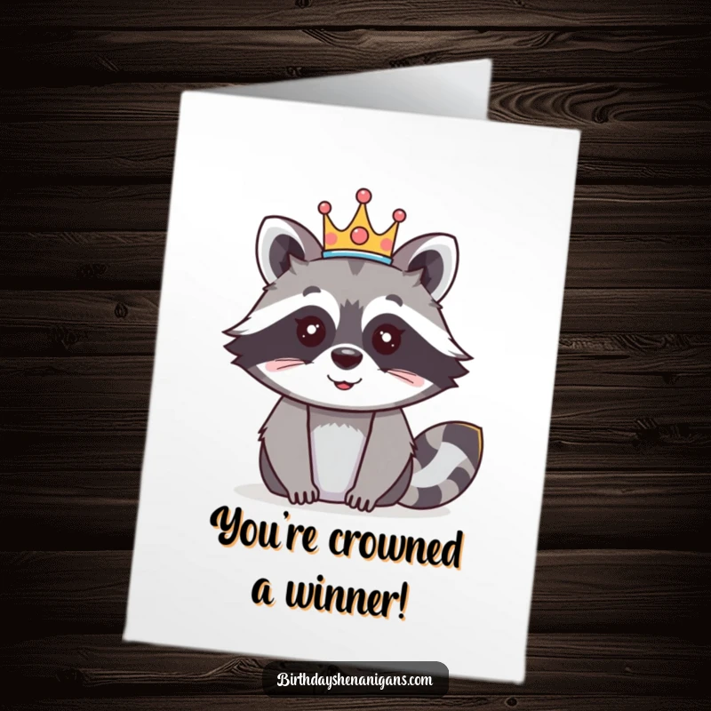 Funny Free Printable Congratulations Card: A happy raccoon wears a festive crown, celebrating success with regal humor.