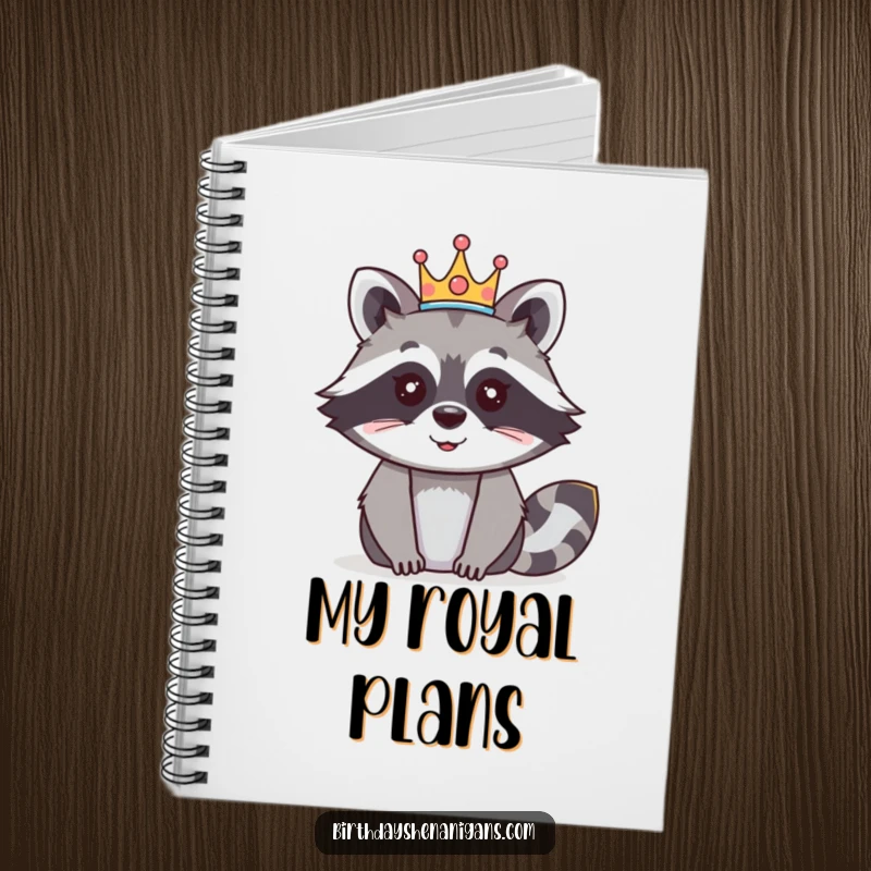 Funny raccoon notebook with a happy character wearing a festive crown, ideal for journaling and royal musings.