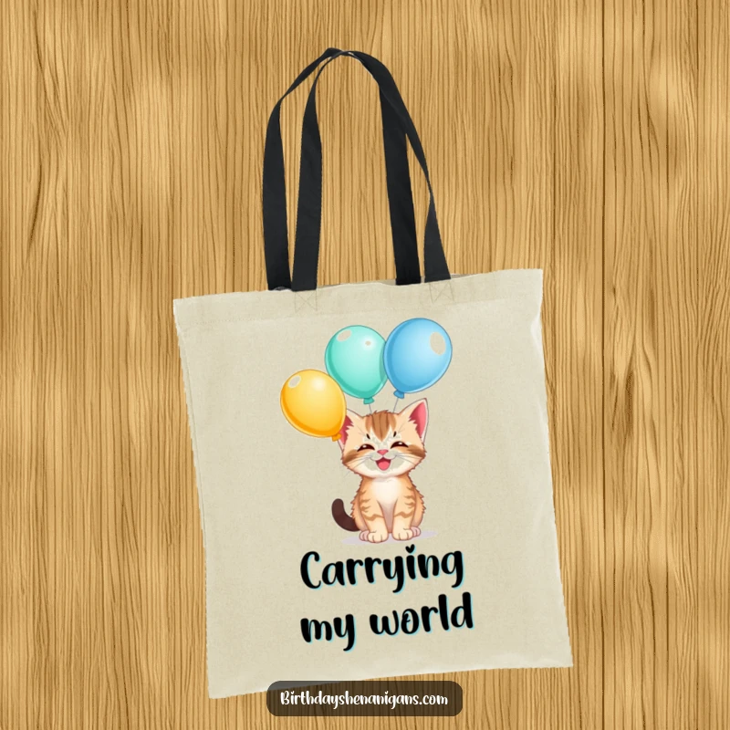 Funny kitten tote bag, giggling, balancing balloons, playful cat theme, carrying items, cute and humorous.