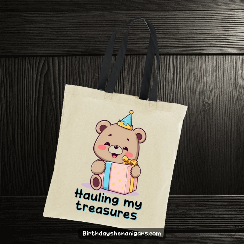Funny tote bag showcasing a smiling bear with a birthday crown, happily unwrapping an oversized gift, ideal for carrying birthday loot.